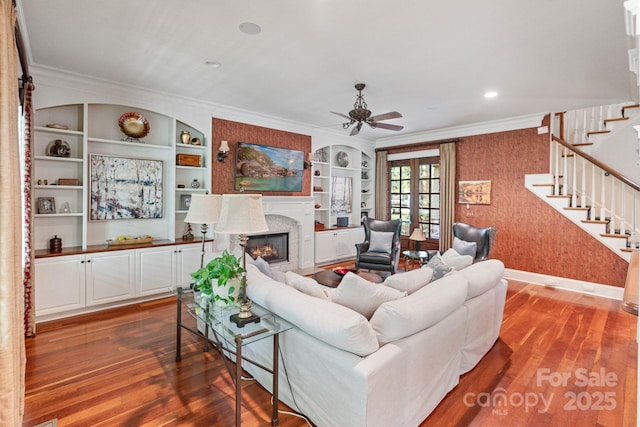 8534 Highgrove St, Charlotte, NC 28277 - living room with stairs, a fireplace, wood finished floors, ceiling fan, and ornamental molding