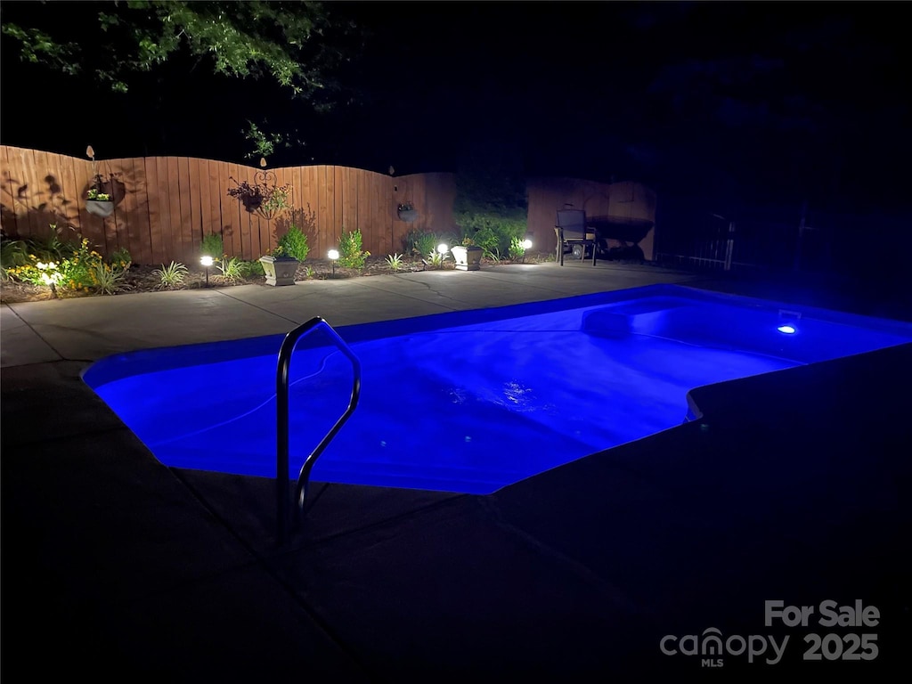 3320 Harvey Ln, Monroe, NC 28110 - pool at twilight with a patio and fence
