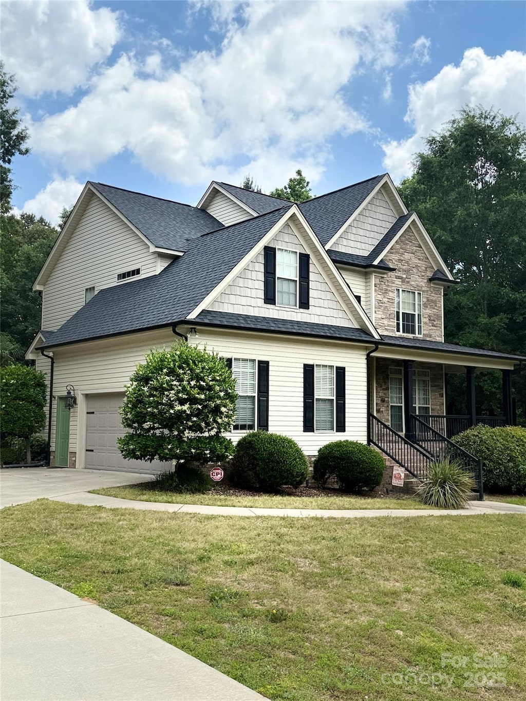 3320 Harvey Ln, Monroe, NC 28110 - view of front facade with driveway, a porch, a front lawn, and an attached garage