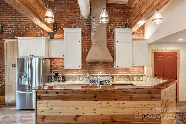 14 N Main St Unit 1 & 2, Waynesville, NC 28786 - kitchen with stainless steel fridge, brick wall, white cabinetry, a high ceiling, and light stone countertops