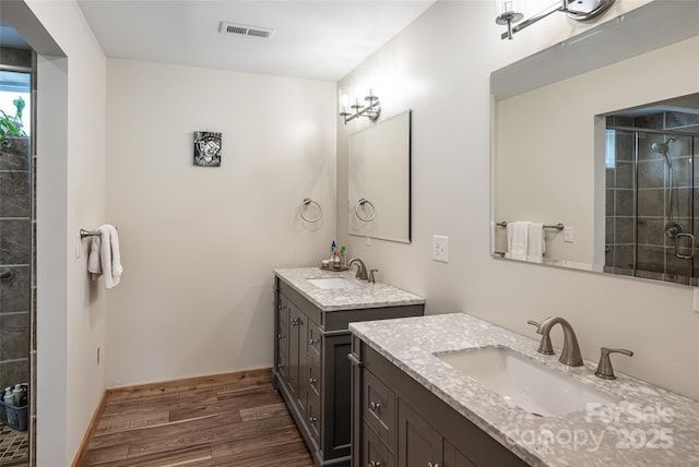 14 N Main St Unit 1 & 2, Waynesville, NC 28786 - full bathroom with a shower stall, two vanities, and wood finished floors
