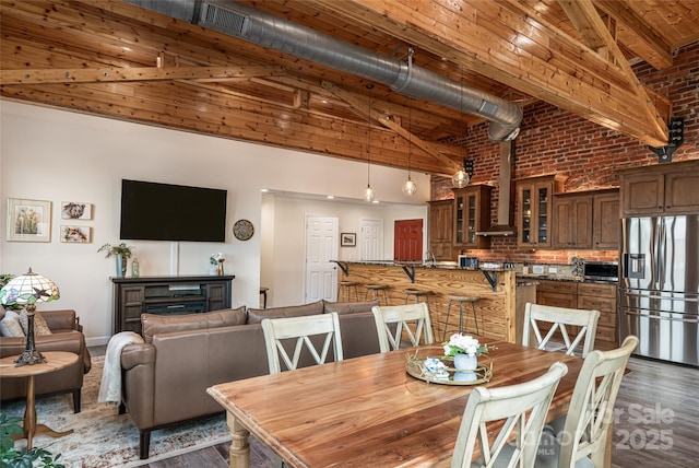 14 N Main St Unit 1 & 2, Waynesville, NC 28786 - dining space featuring wood finished floors, high vaulted ceiling, beam ceiling, wood ceiling, and brick wall