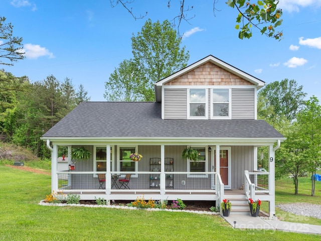 9 Ruff Rd, Leicester, NC 28748 - view of front facade featuring covered porch, a shingled roof, and a front lawn