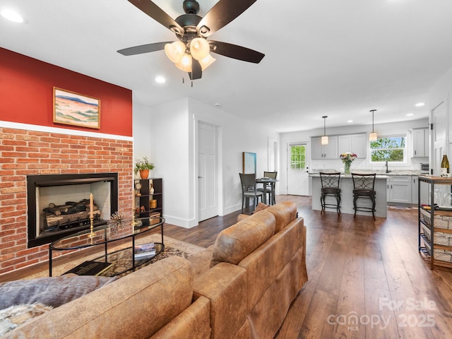 9 Ruff Rd, Leicester, NC 28748 - living area featuring dark wood-style flooring, recessed lighting, a ceiling fan, a fireplace, and baseboards