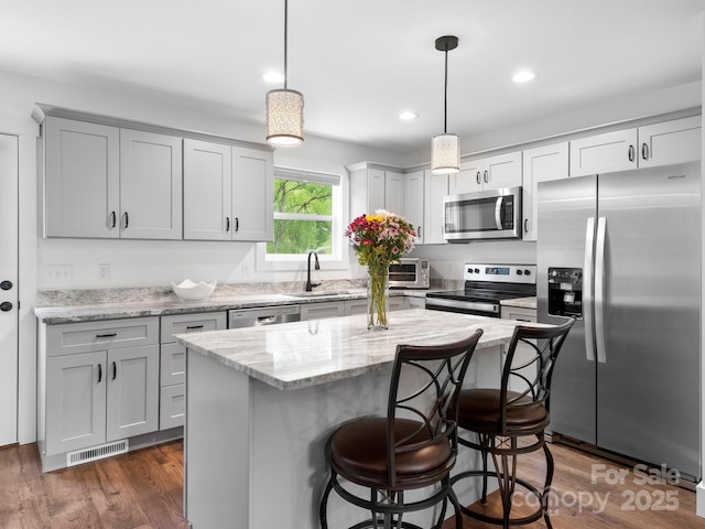 9 Ruff Rd, Leicester, NC 28748 - kitchen featuring stainless steel appliances, a sink, a kitchen island, a kitchen bar, and hanging light fixtures