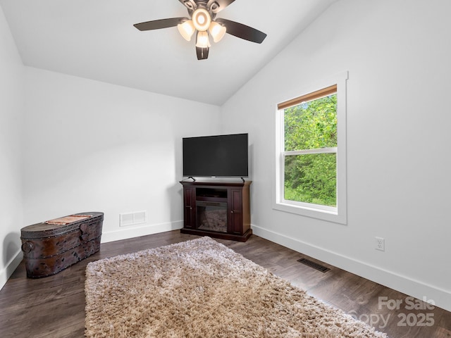 9 Ruff Rd, Leicester, NC 28748 - living area featuring vaulted ceiling, ceiling fan, baseboards, a glass covered fireplace, and dark wood finished floors
