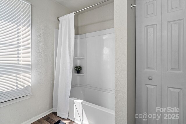 1961 Leesburg Dr, Clover, SC 29710 - bathroom with baseboards, shower / bath combo with shower curtain, wood finished floors, and a closet