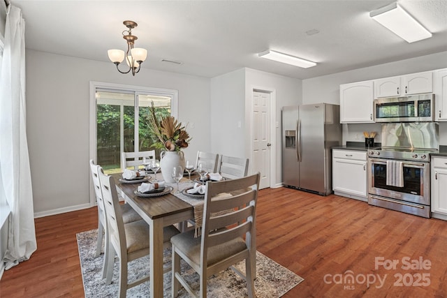 1961 Leesburg Dr, Clover, SC 29710 - dining space with light wood finished floors, baseboards, and a chandelier