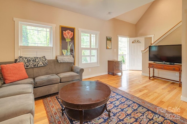 104 Bobby Ridge Dr, Leicester, NC 28748 - living area featuring light wood-style flooring, vaulted ceiling, and baseboards