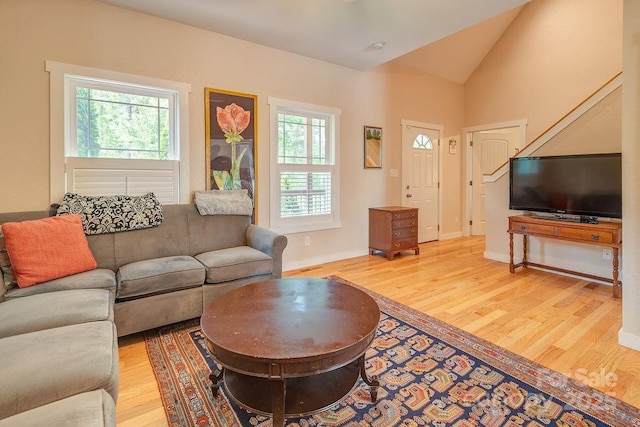 104 Bobby Ridge Dr, Leicester, NC 28748 - living room with light wood-style flooring, healthy amount of natural light, lofted ceiling, and baseboards