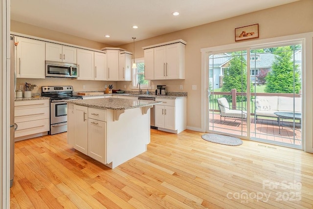 104 Bobby Ridge Dr, Leicester, NC 28748 - kitchen with appliances with stainless steel finishes, light wood-style flooring, recessed lighting, and white cabinetry