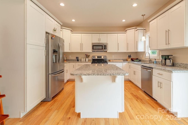 104 Bobby Ridge Dr, Leicester, NC 28748 - kitchen with appliances with stainless steel finishes, a sink, a center island, white cabinets, and recessed lighting