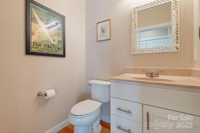 104 Bobby Ridge Dr, Leicester, NC 28748 - half bath featuring toilet, vanity, baseboards, and wood finished floors