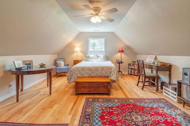 104 Bobby Ridge Dr, Leicester, NC 28748 - bedroom featuring a textured ceiling, wood finished floors, lofted ceiling, baseboards, and ceiling fan