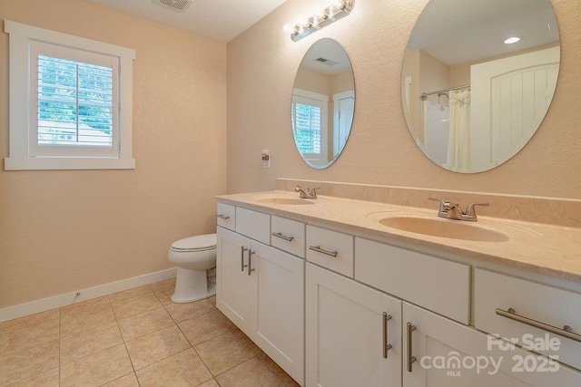 104 Bobby Ridge Dr, Leicester, NC 28748 - bathroom featuring double vanity, toilet, tile patterned floors, and baseboards