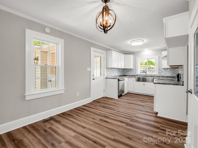 411 W Sycamore St, Lincolnton, NC 28092 - kitchen featuring stainless steel dishwasher, a chandelier, a sink, backsplash, and dark wood-type flooring