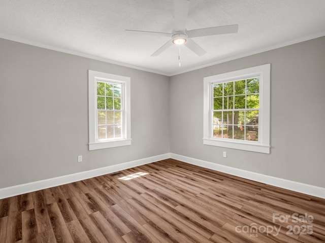 411 W Sycamore St, Lincolnton, NC 28092 - spare room featuring ornamental molding, wood finished floors, baseboards, ceiling fan, and a textured ceiling