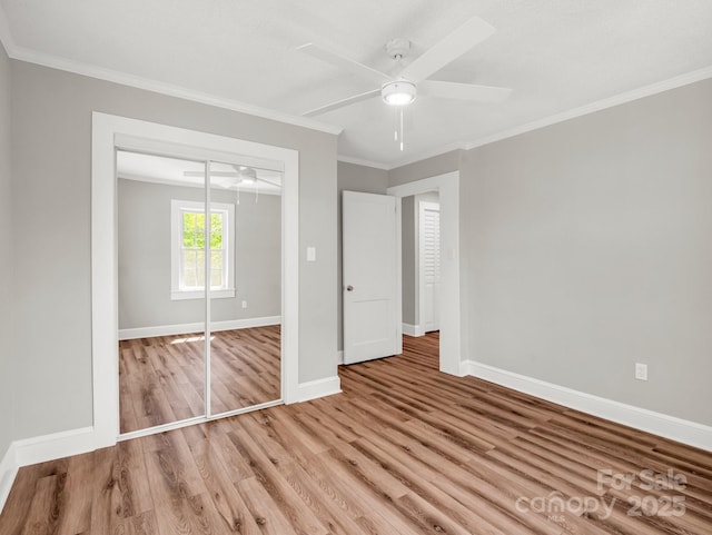 411 W Sycamore St, Lincolnton, NC 28092 - unfurnished bedroom with wood finished floors, baseboards, ornamental molding, and a closet