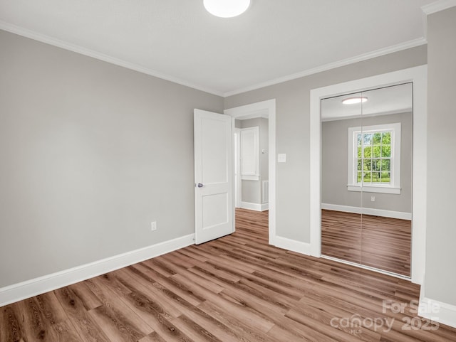 411 W Sycamore St, Lincolnton, NC 28092 - unfurnished bedroom featuring ornamental molding, wood finished floors, baseboards, and a closet