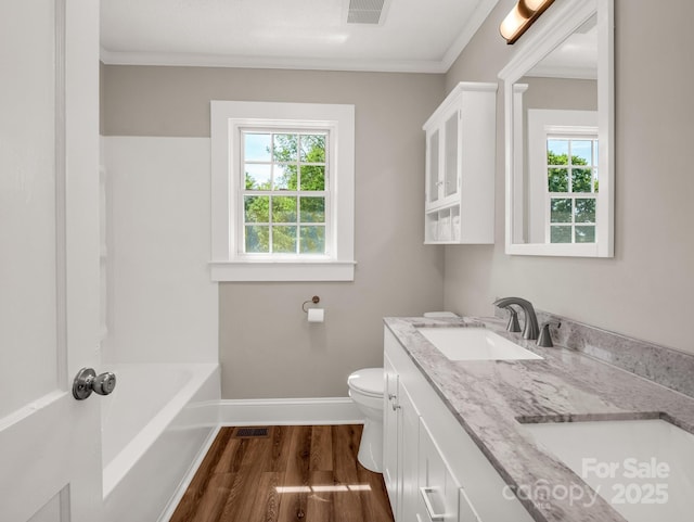 411 W Sycamore St, Lincolnton, NC 28092 - full bathroom with baseboards, wood finished floors, toilet, double vanity, and ornamental molding