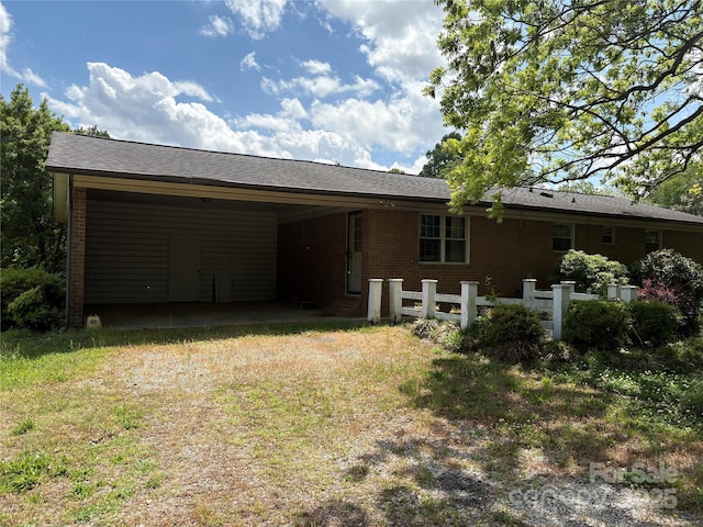 947 Ravendale Dr, Charlotte, NC 28216 - rear view of house with a carport, driveway, and brick siding