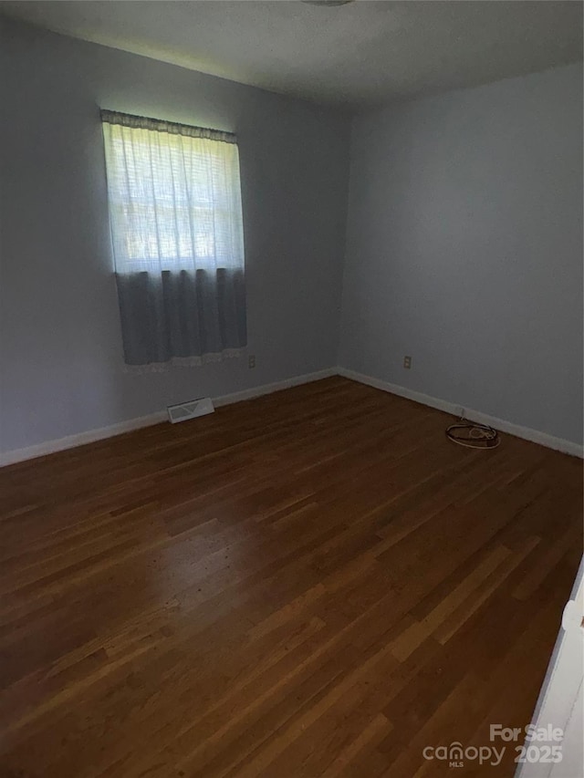 947 Ravendale Dr, Charlotte, NC 28216 - empty room featuring wood finished floors and baseboards