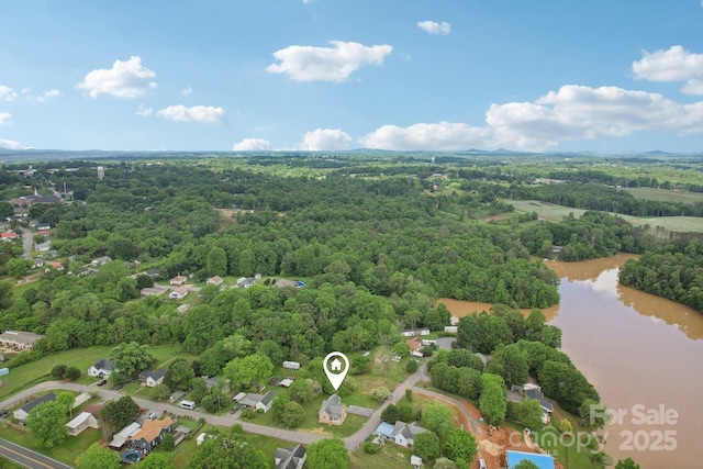 bird's eye view of a nearby body of water and a forest
