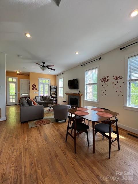 115 Breakaway Trl, Mars Hill, NC 28754 - dining room featuring healthy amount of natural light, light wood-type flooring, a fireplace, recessed lighting, and baseboards