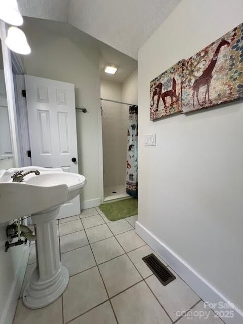 115 Breakaway Trl, Mars Hill, NC 28754 - bathroom with a shower stall, tile patterned floors, and baseboards