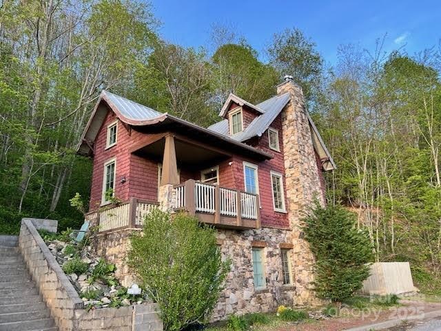 115 Breakaway Trl, Mars Hill, NC 28754 - view of property exterior featuring a balcony, stone siding, and a chimney