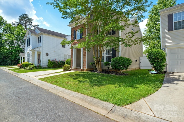 view of front facade featuring a front yard and concrete driveway