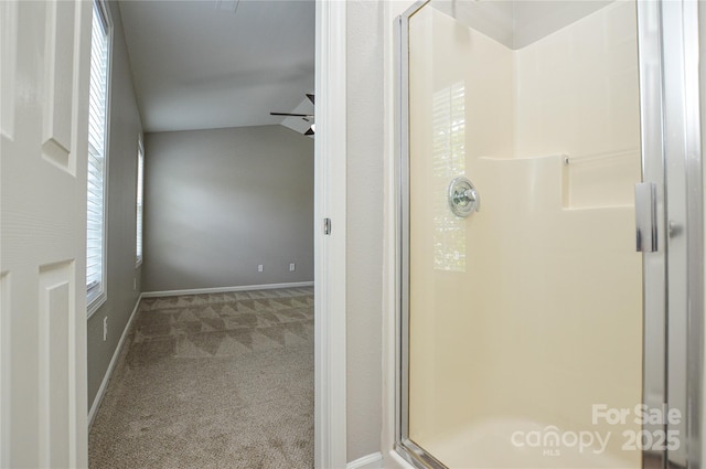 full bath with a shower stall and baseboards