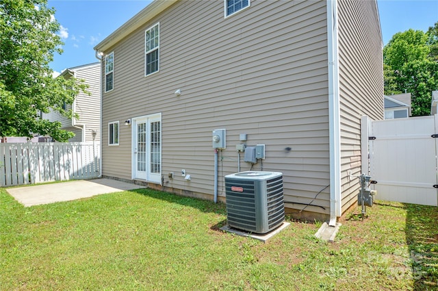 rear view of property featuring central AC and a patio