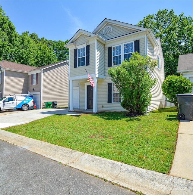 7311 Fig Ln, Charlotte, NC 28215 - view of front of house featuring driveway, a front yard, and a garage