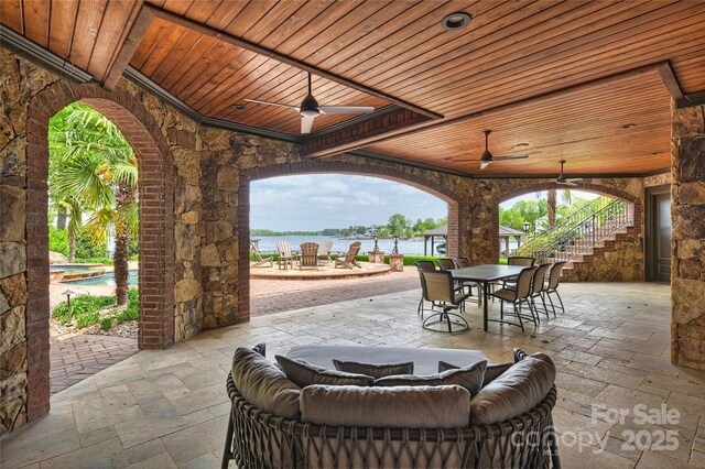16909 Jetton Rd, Cornelius, NC 28031 - view of patio with outdoor dining space, ceiling fan, stairway, and a water view