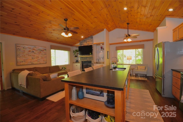 220 Woodwinds Ln, Seven Devils, NC 28604 - kitchen with a sink, freestanding refrigerator, ceiling fan, dark countertops, and open floor plan
