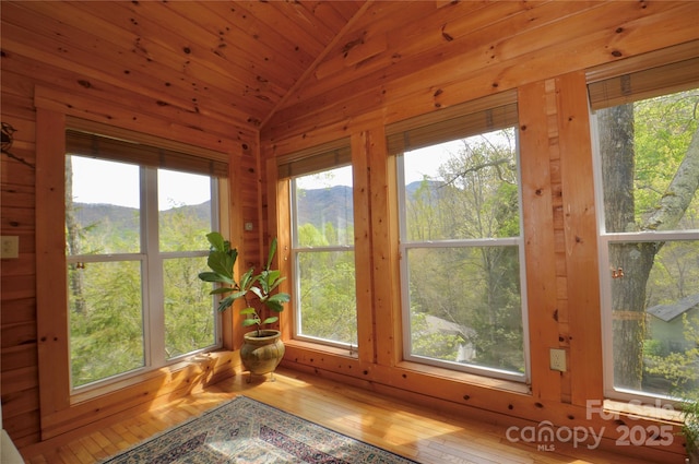220 Woodwinds Ln, Seven Devils, NC 28604 - unfurnished sunroom with vaulted ceiling, healthy amount of natural light, and wood finished floors