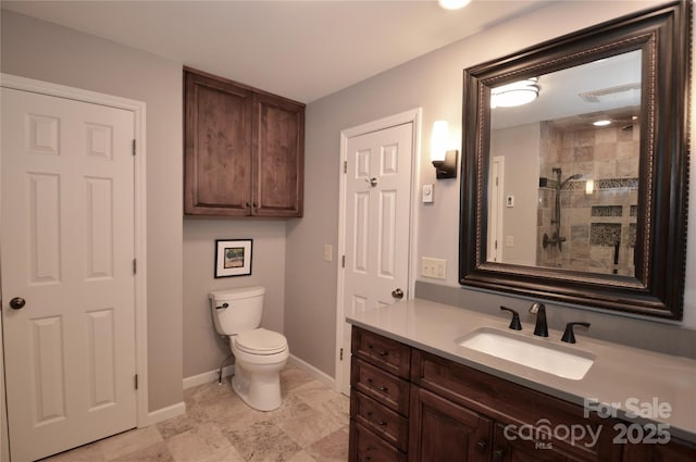 220 Woodwinds Ln, Seven Devils, NC 28604 - bathroom featuring toilet, tiled shower, vanity, and baseboards