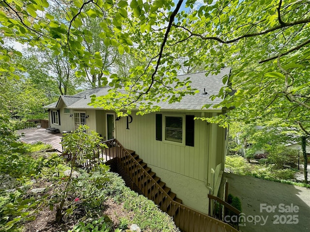 220 Woodwinds Ln, Seven Devils, NC 28604 - view of front facade with roof with shingles and stairway