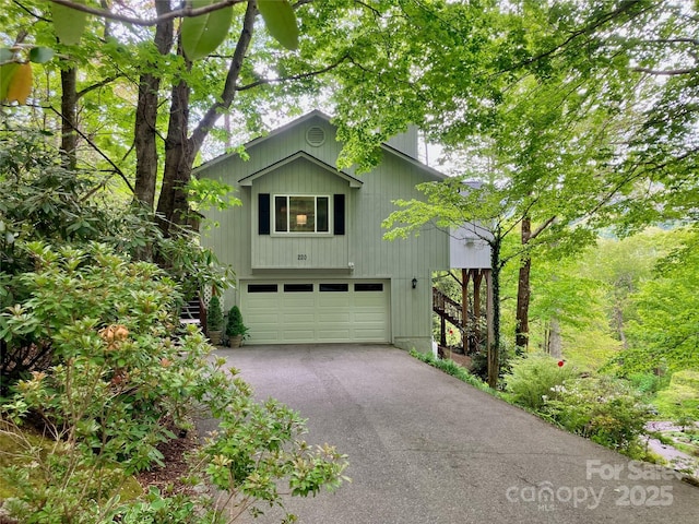 220 Woodwinds Ln, Seven Devils, NC 28604 - view of front of property with stairway, an attached garage, and asphalt driveway