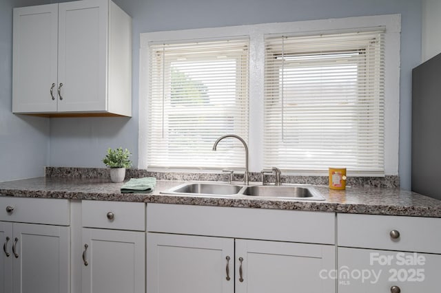 520 E Maple Ave, Gastonia, NC 28054 - kitchen featuring a sink and white cabinetry