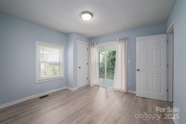 520 E Maple Ave, Gastonia, NC 28054 - empty room featuring a textured ceiling, wood finished floors, and baseboards