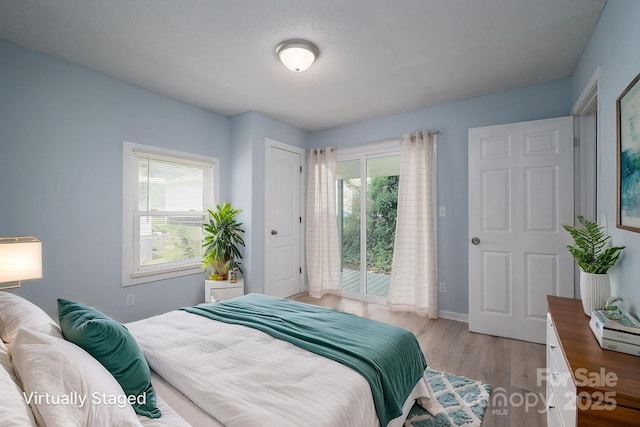 520 E Maple Ave, Gastonia, NC 28054 - bedroom featuring access to exterior, light wood-type flooring, and baseboards