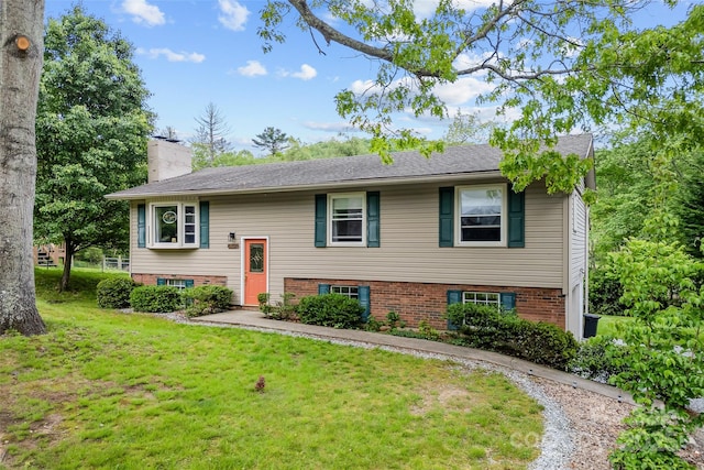 split foyer home with a front lawn and a chimney