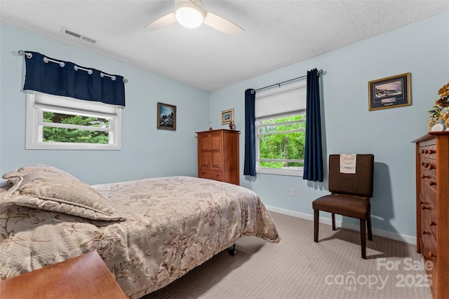 carpeted bedroom featuring baseboards and ceiling fan