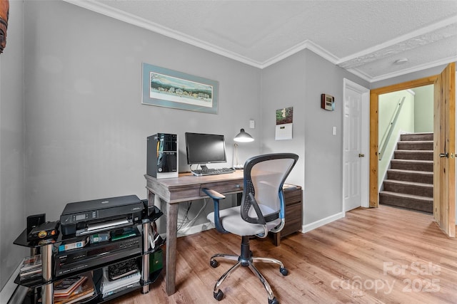 office space featuring wood finished floors, a textured ceiling, baseboards, and crown molding