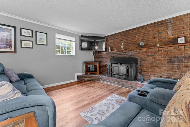 living area with crown molding, baseboards, wood finished floors, and a textured ceiling