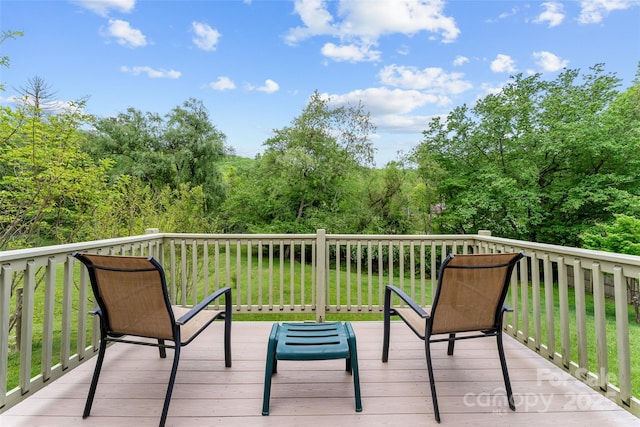 wooden deck with a view of trees