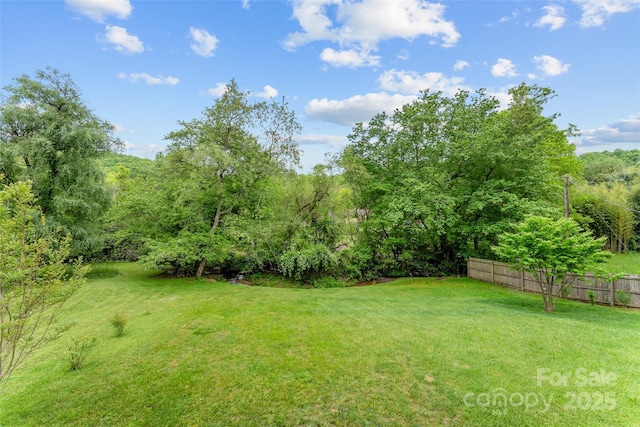 view of yard with a view of trees