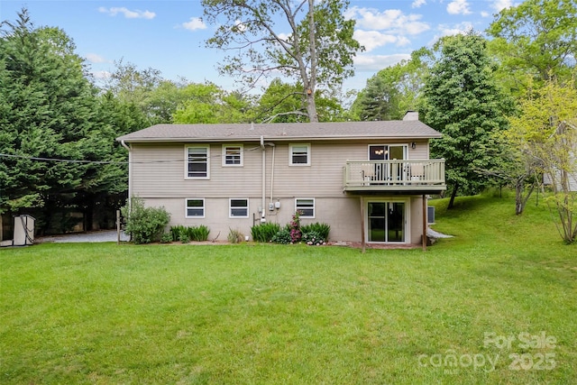 back of property with a lawn, a deck, and a chimney